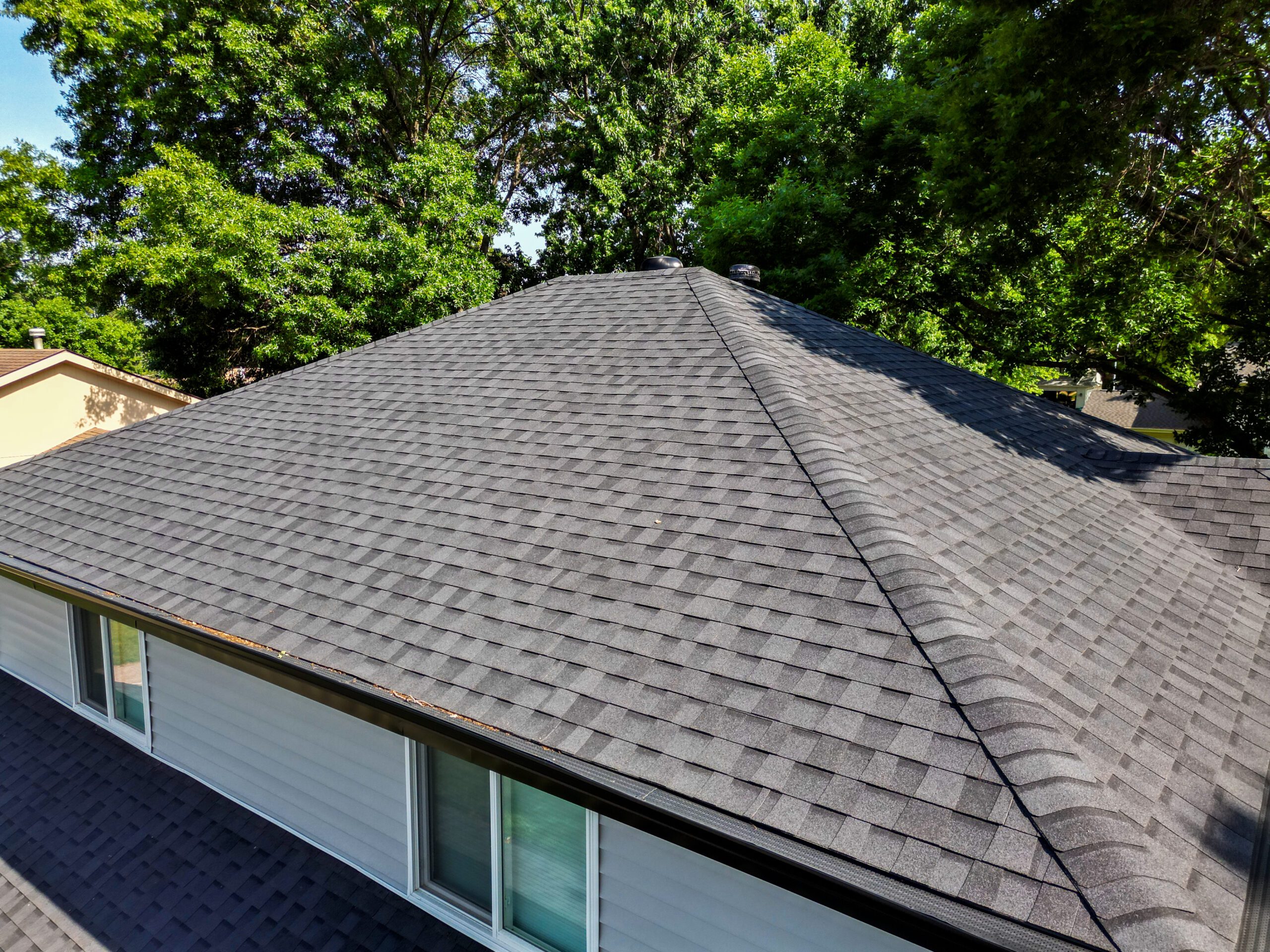 Roof ridge and shingle texture detail on newly completed Iowa home roof.