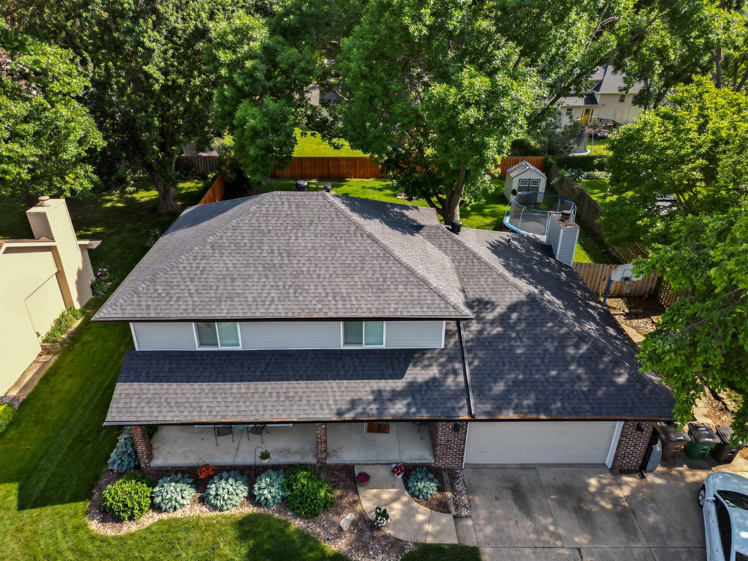 Aerial view of entire asphalt shingle roof installation.