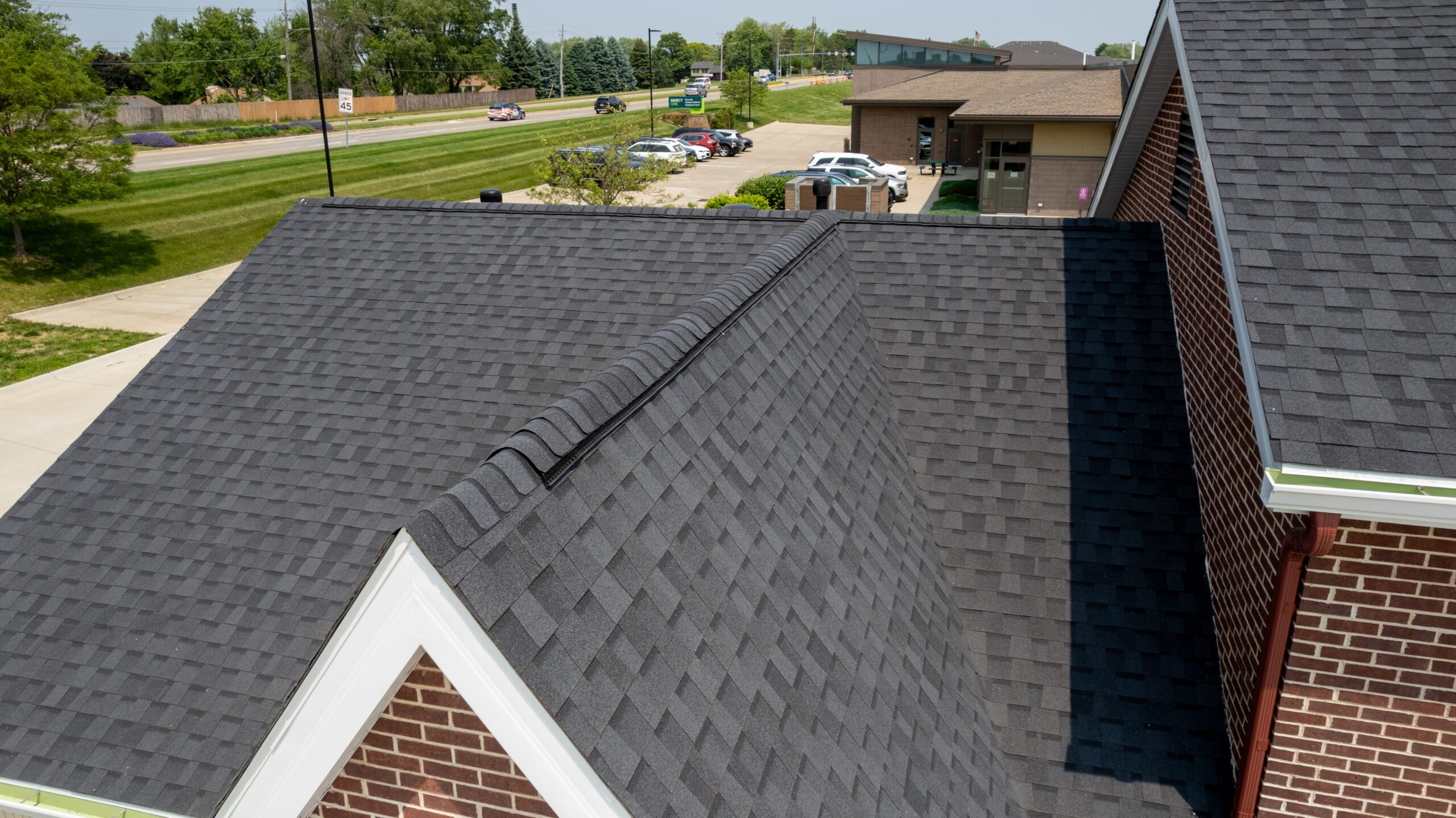 Close-up view of CertainTeed asphalt shingles installed by Wolf Roofing on Christian Brothers Automotive