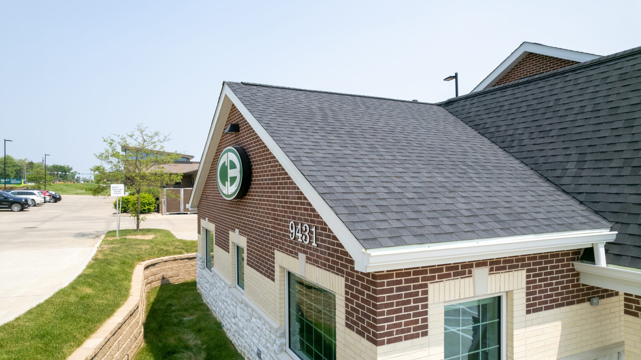 Front gable view of Christian Brothers Automotive with logo and new shingles