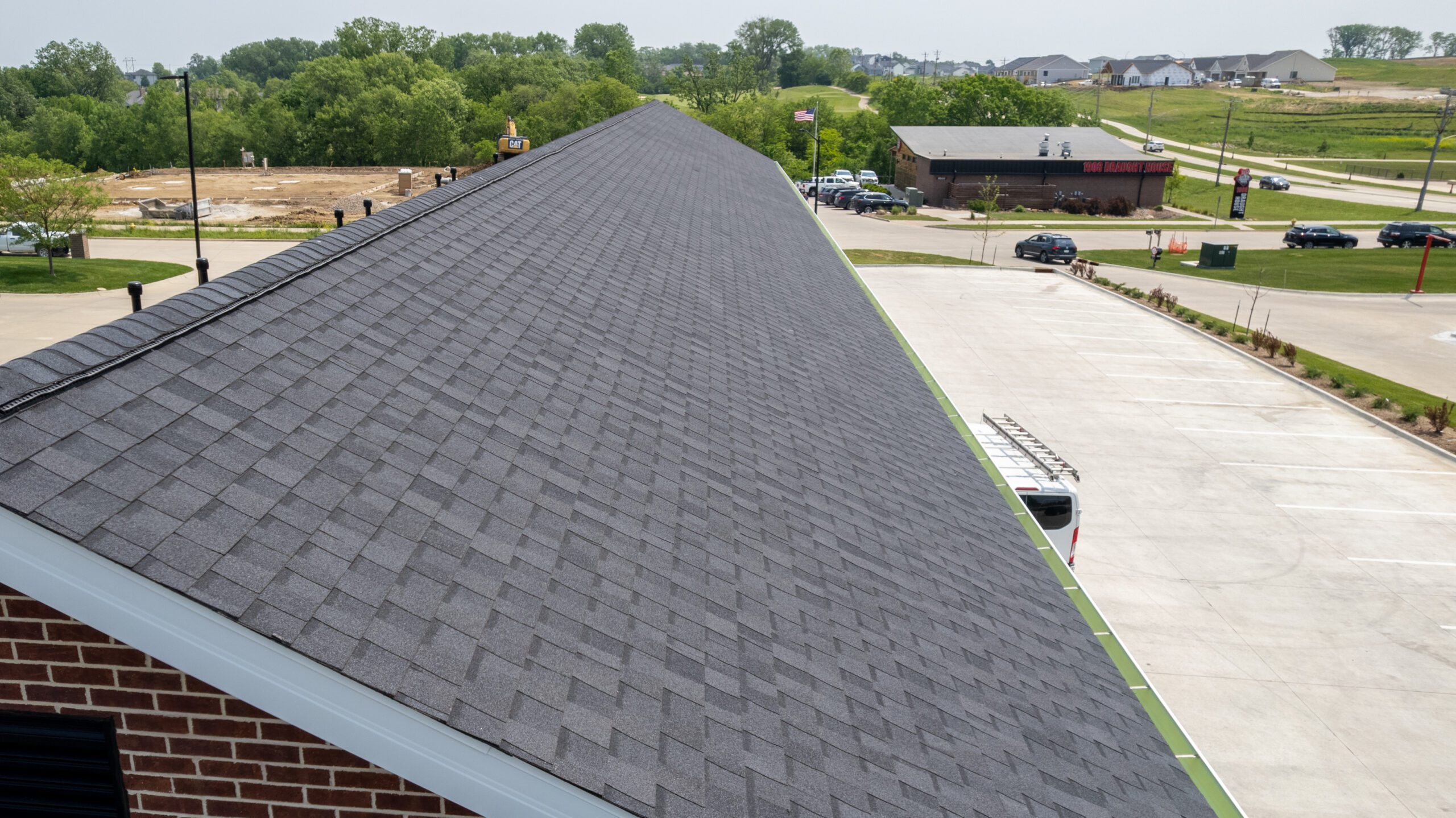 Angled view of Christian Brothers Automotive showing the long side of the building and roof