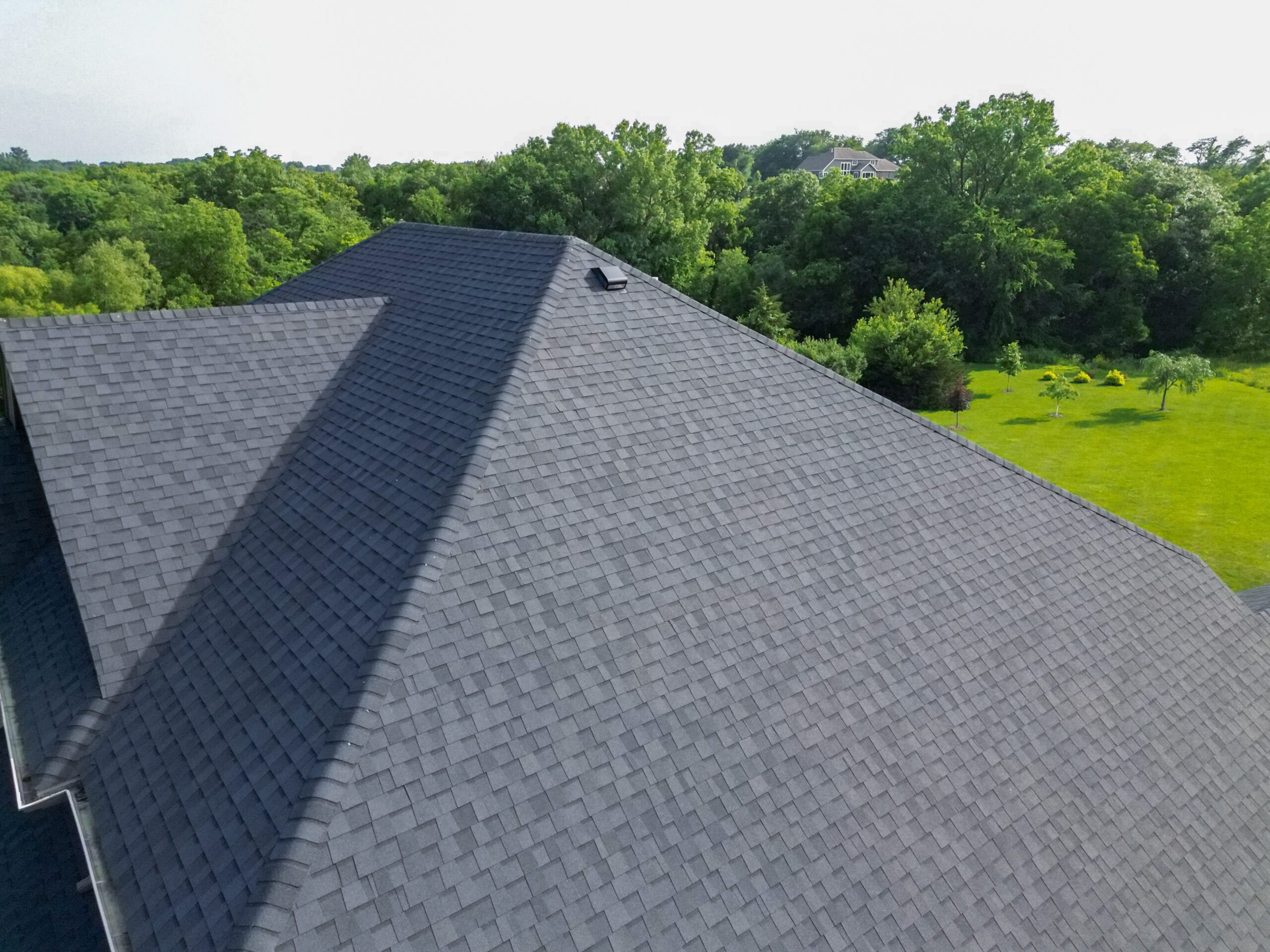 Right-side aerial view of Wolf Roofing installation on a residential home