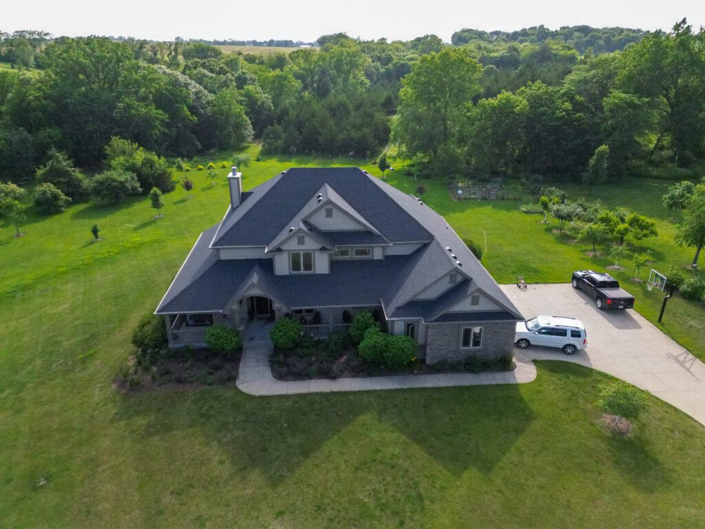 Elevated front view of a complete asphalt shingle roof by Wolf Roofing