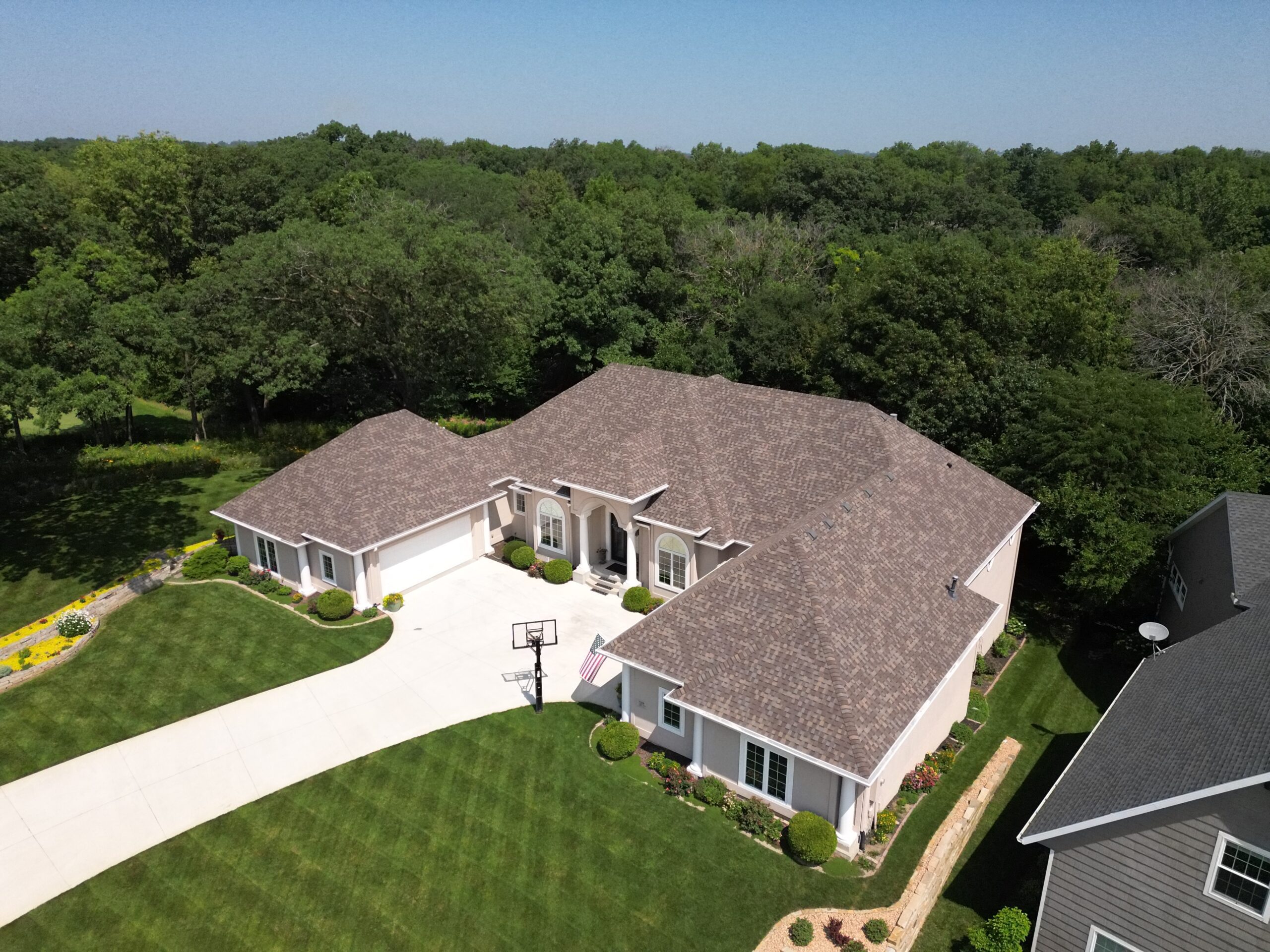 Aerial front angle of complete residential roof replacement in Polk City by Wolf Roofing.
