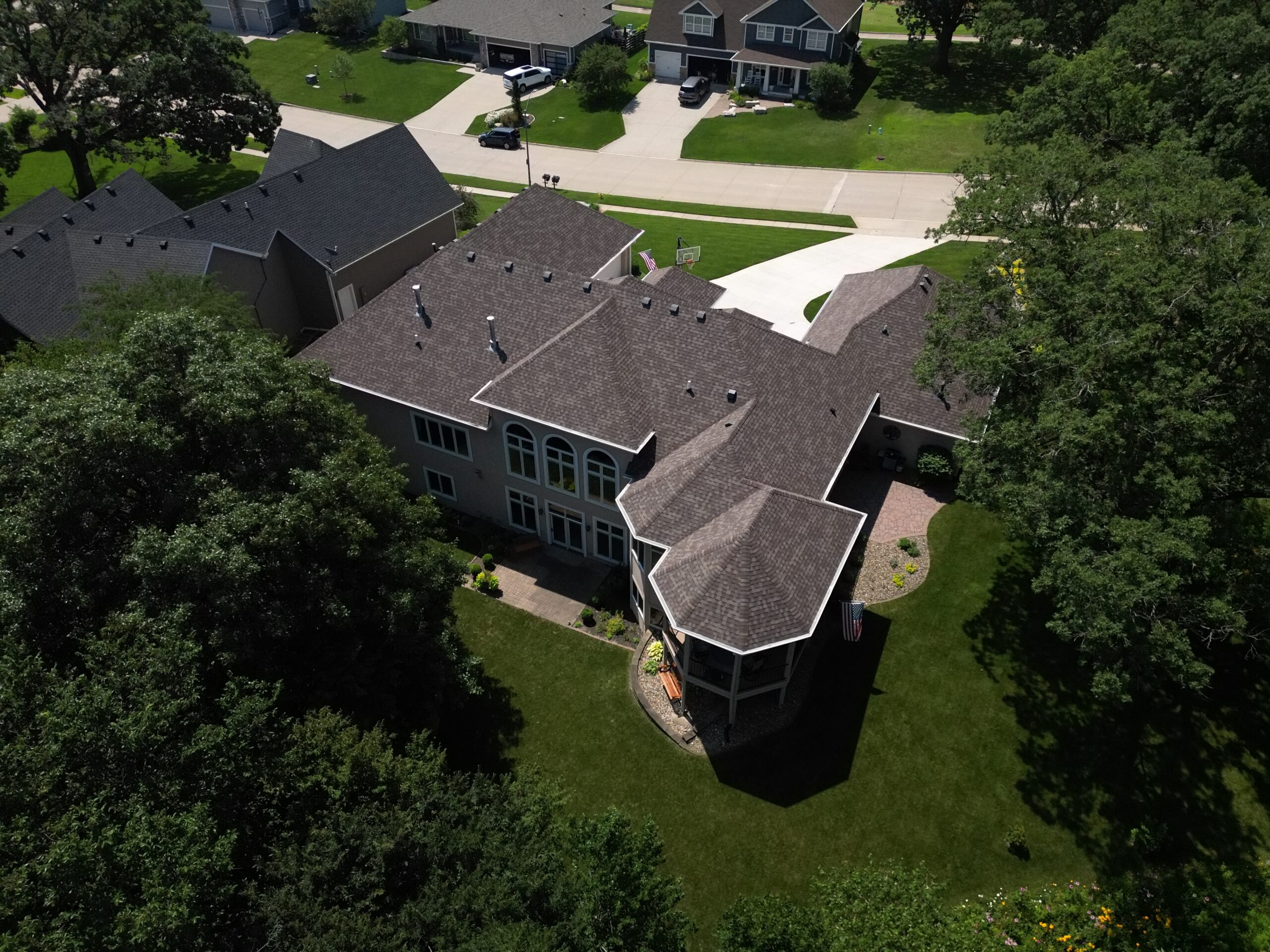 Rear aerial view of new roof installation with complex valleys and ridges in Polk City
