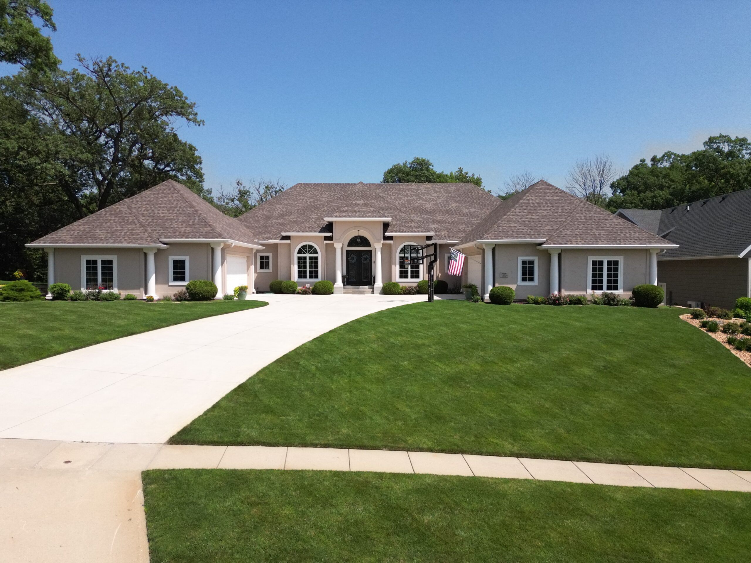 Front view of large Polk City home with new asphalt shingle roof installed by Wolf Roofing