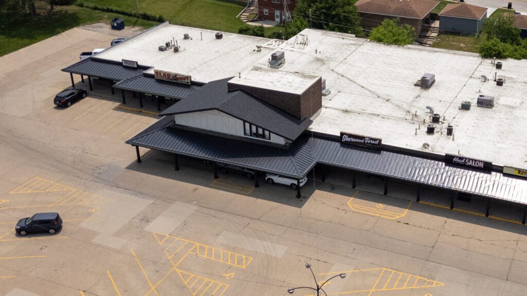 Angled aerial view of Sherwood Forest center showing shingled section and business signage