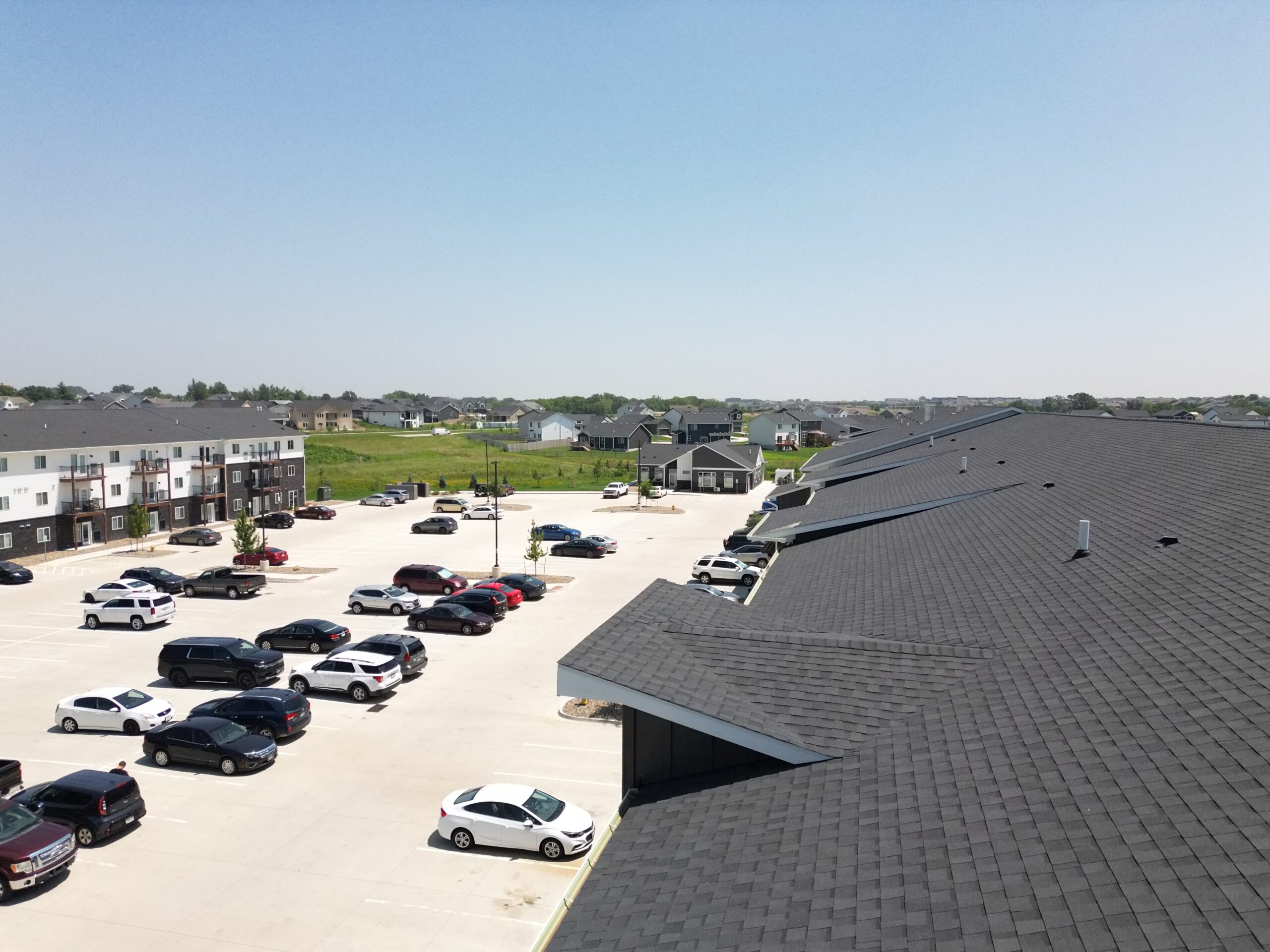 Rear view of intersecting slopes, sharp ridgelines, and uniform shingle finish