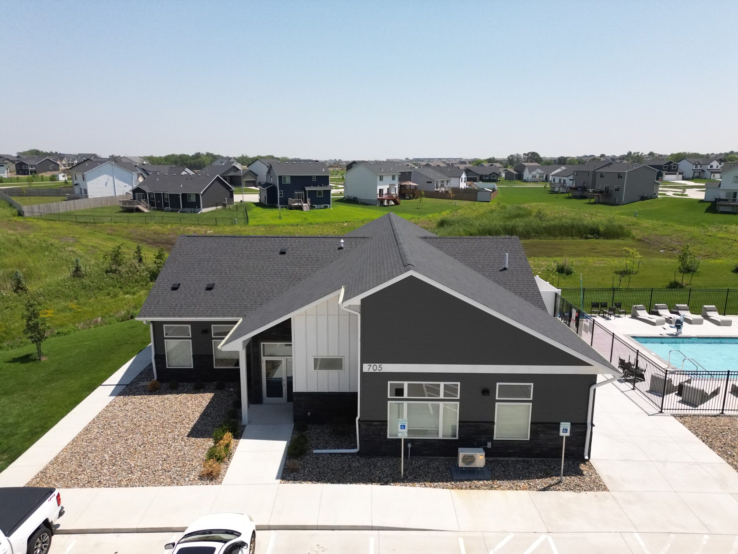 Straight-on view of the Pitch Apartments building with completed asphalt shingle roofing