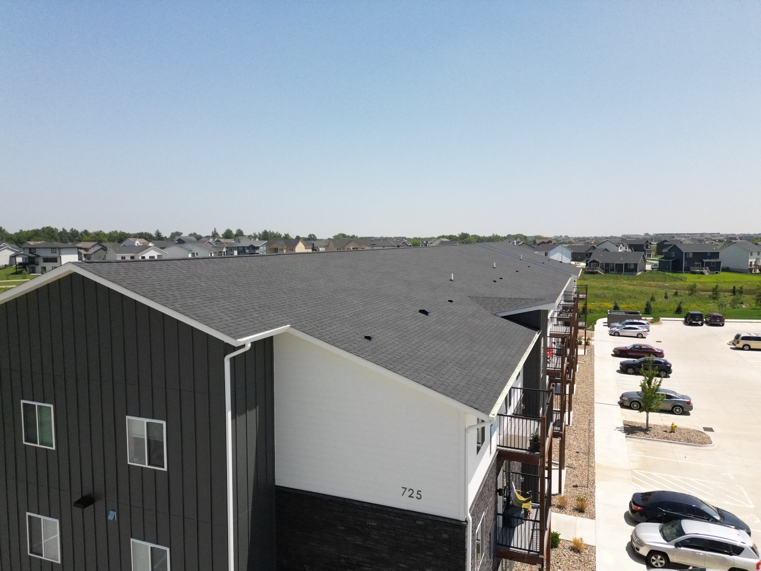 Left side view of The Pitch Apartments roof installation by Wolf Roofing