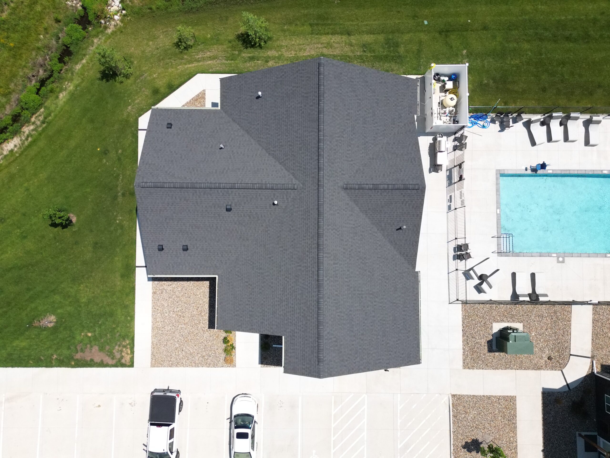 Top-down drone view of The Pitch Apartments clubhouse roof and pool area