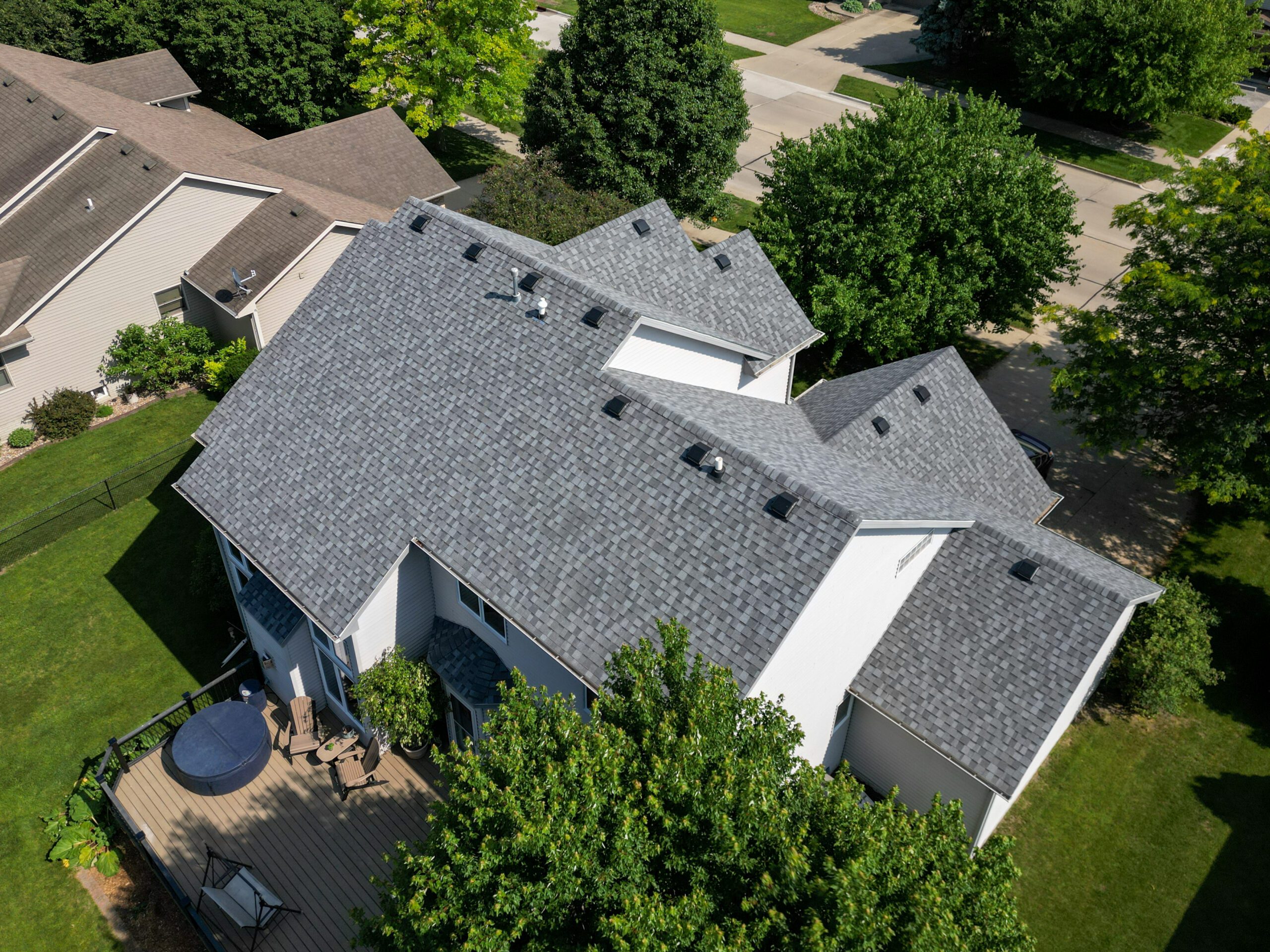 Rear angle aerial view of a home with newly installed asphalt shingles