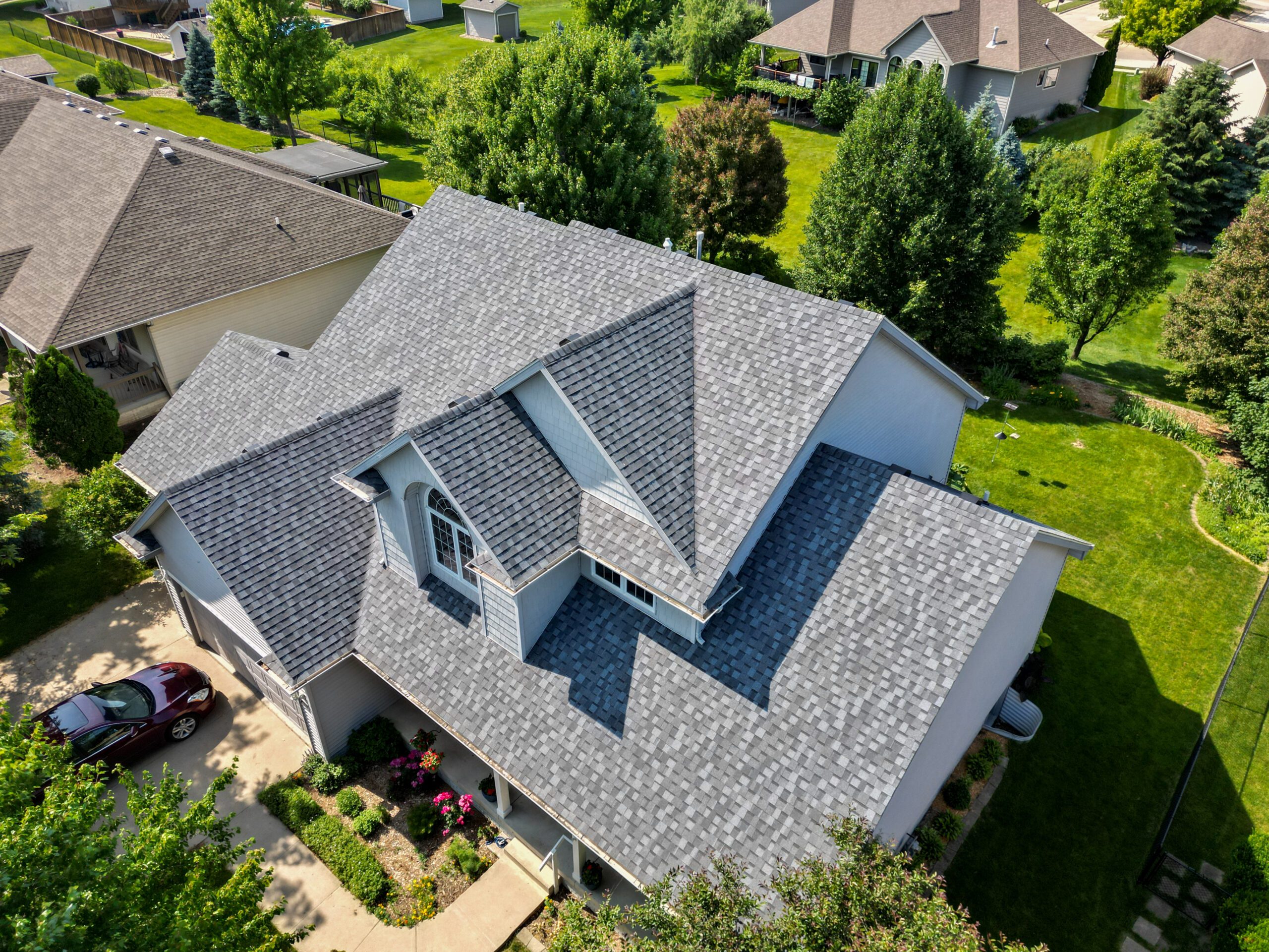 Aerial view from the right showcasing the new roof on an Urbandale home
