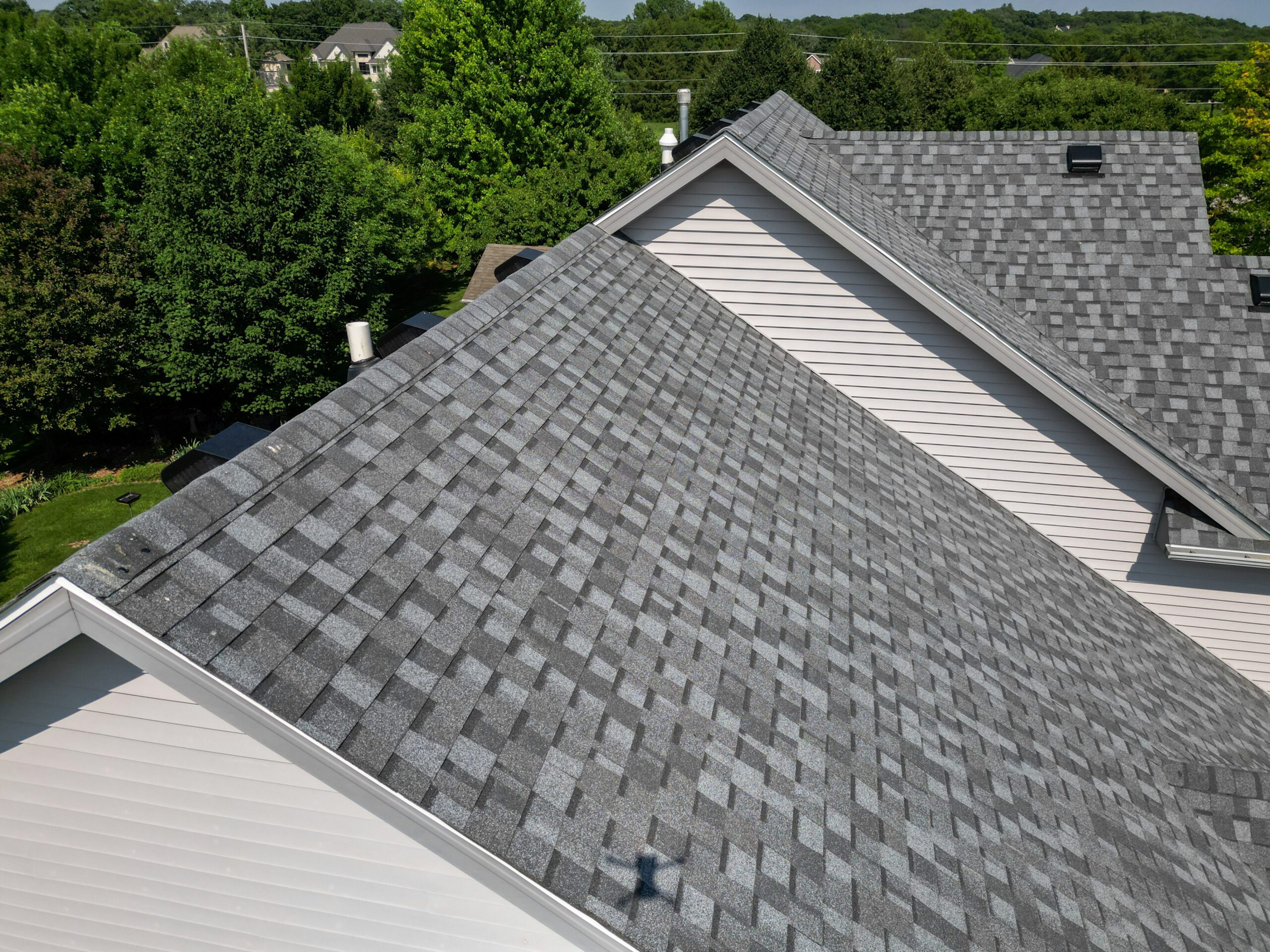 Profile view of new roof showing layered shingles and ridge vent detail