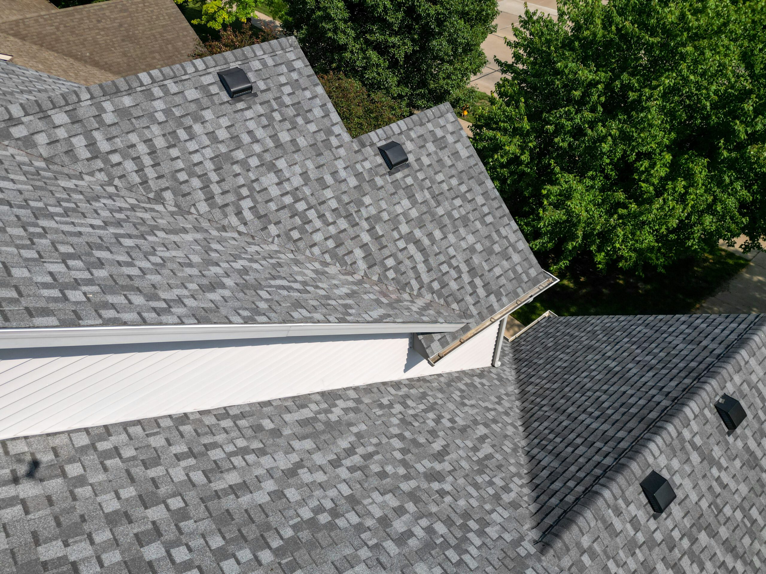 Top-down view showing the new asphalt shingles and ridge layout