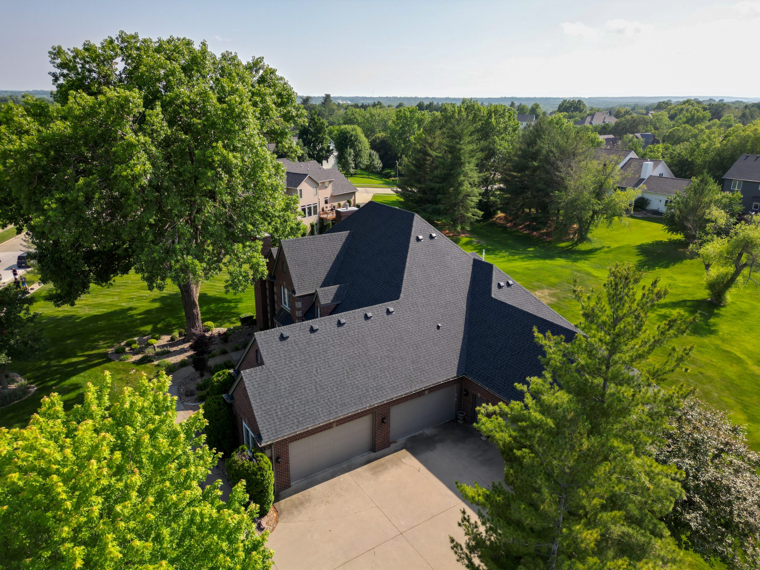 Aerial side view of home with new roof in West Des Moines.