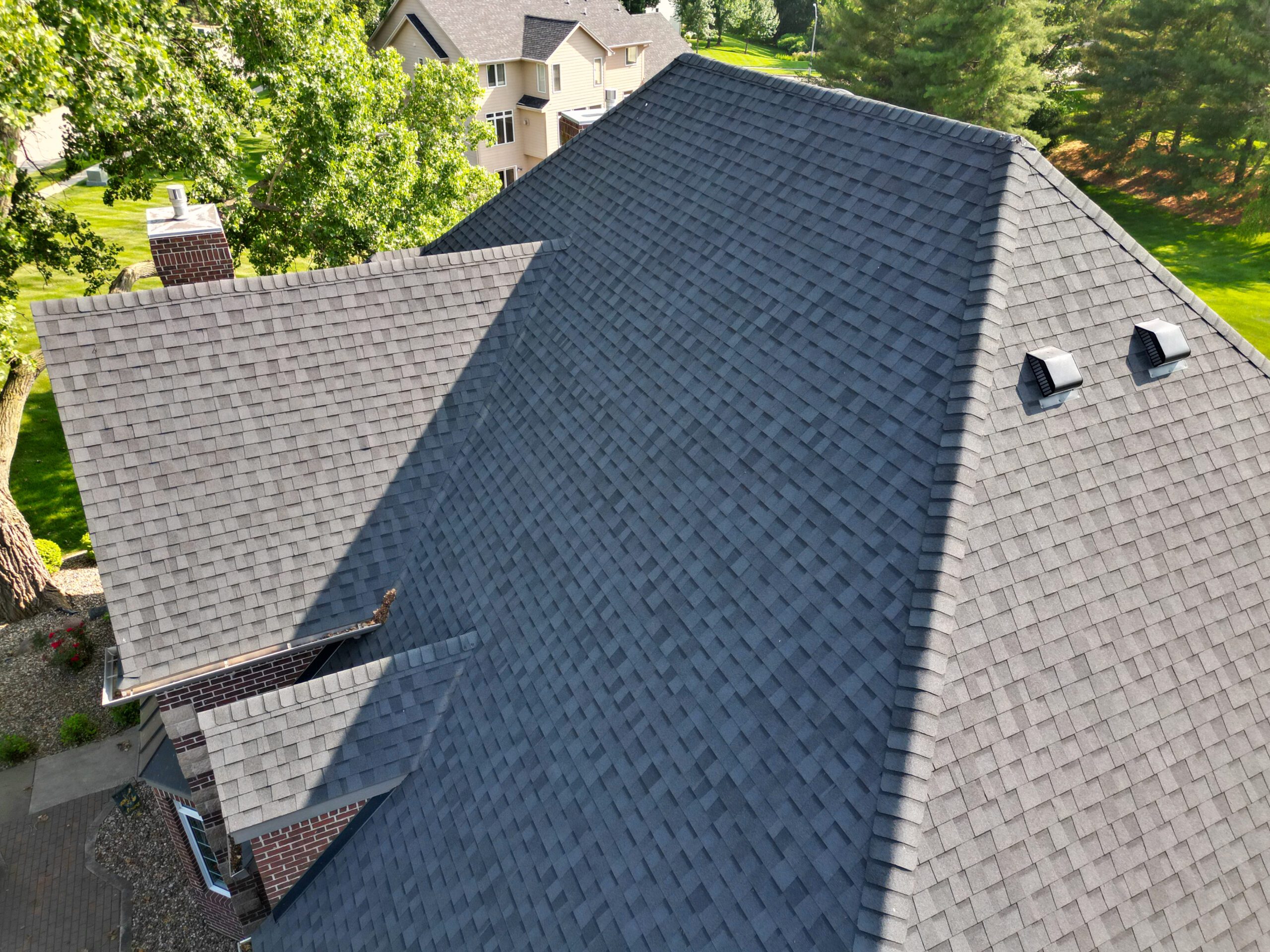 Front-facing aerial roof view with dormers and multiple rooflines