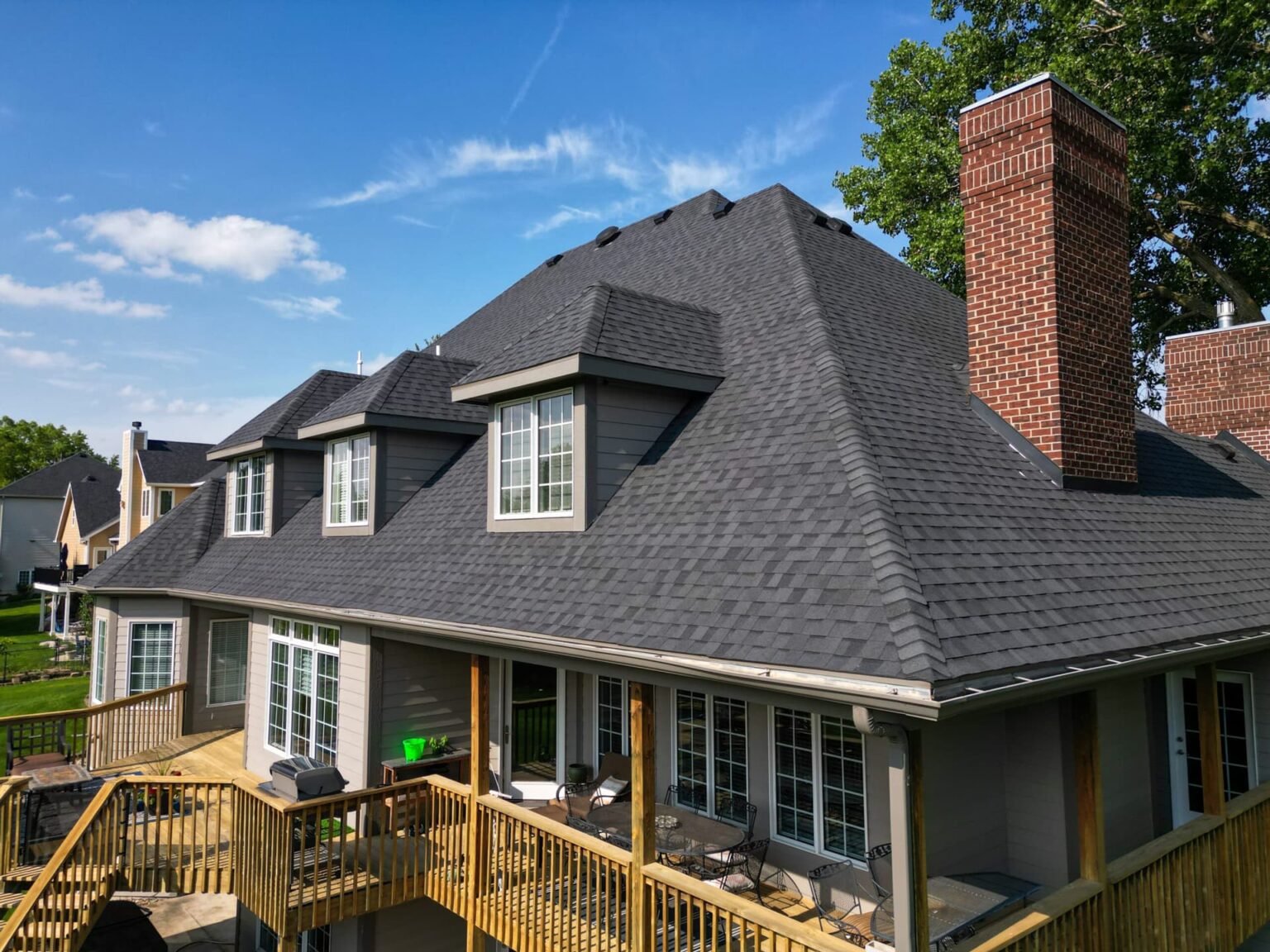 west-des-moines-iowa-home-roofing-rear-straight-view-wolf-roofing-scaled-min Rear straight-on view of completed roof and covered deck