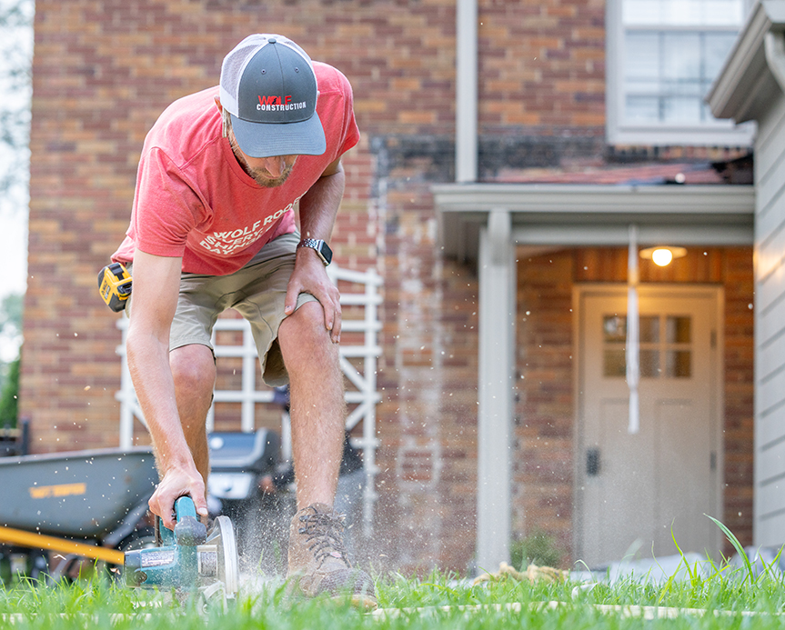 Worker repairing a roof in Central Iowa for Wolf Roofing