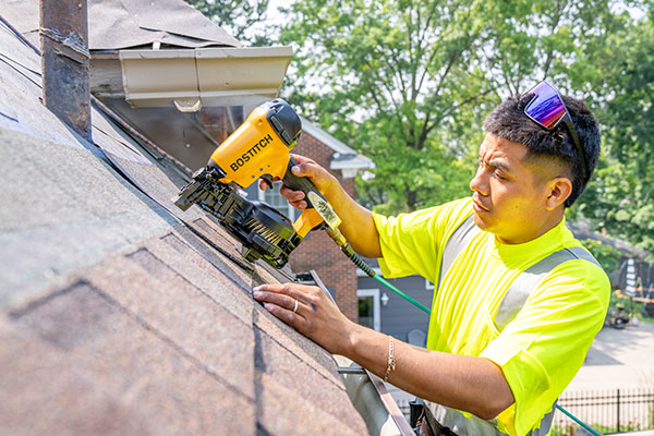 Worker from Wolf Roofing installing new roof in Central Iowa