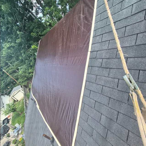 tarp Tarp installed to protect home from water damage until repairs can begin
