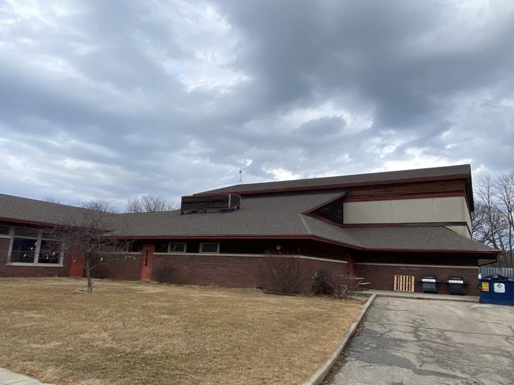 Commercial building with an aging steep-slope roof in Central Iowa