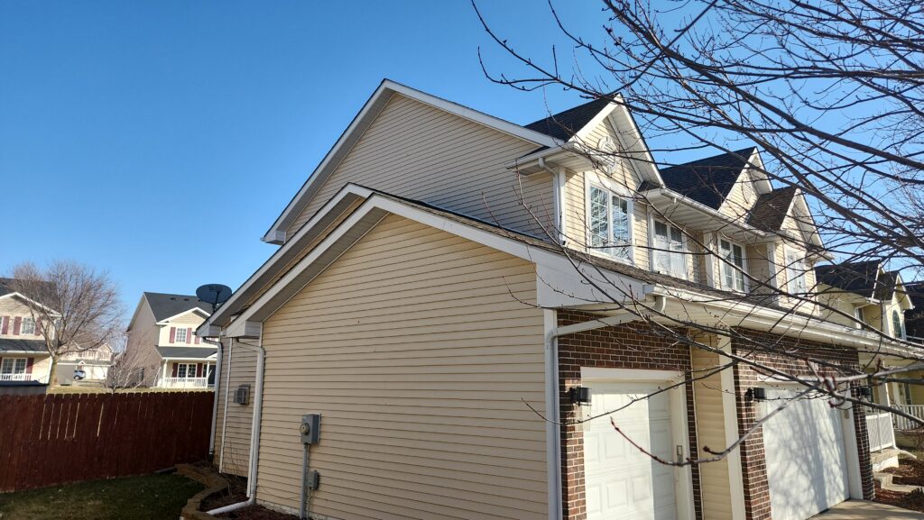 Aging roof above the garage before replacement in Ankeny