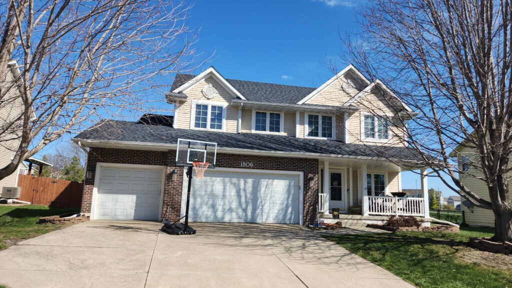 Ankeny two-story home with a new impact resistant roof in CertainTeed NorthGate Moire Black