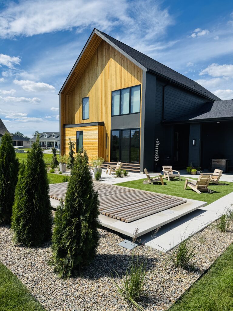 Finished new construction home with a black shingle roof