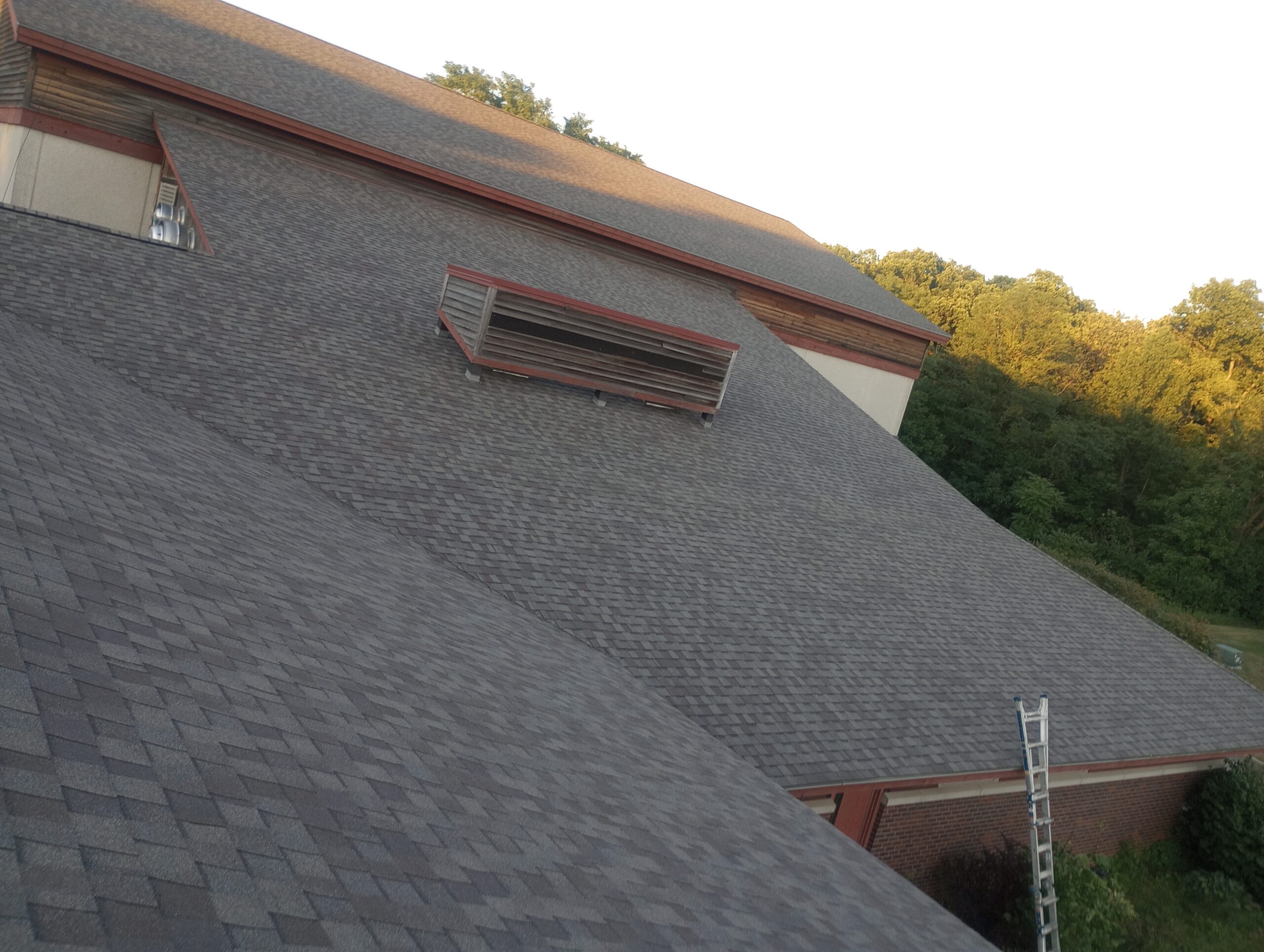 johnston-ia-community-center-new-shingle-roof-vent Roof vent flashed into new architectural shingles in Johnston, IA