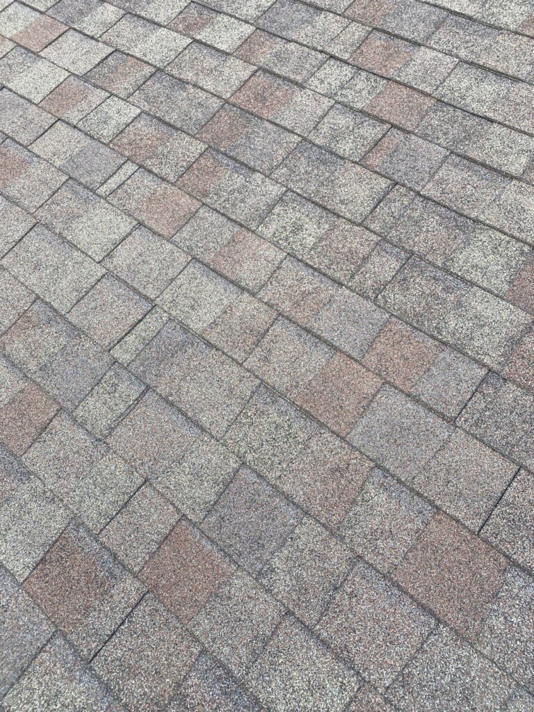 johnston-ia-worn-asphalt-shingles-before-replacement Worn asphalt shingles on a Johnston, IA community center before replacement