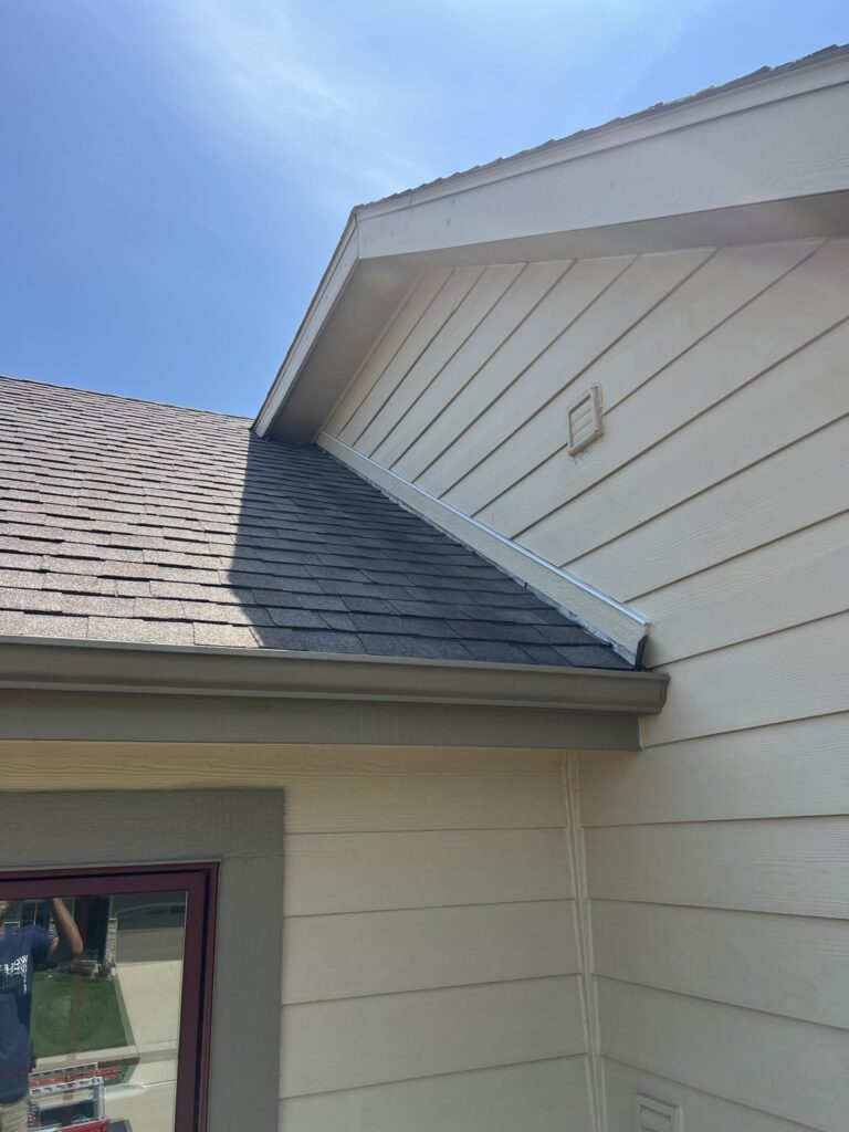 K-style seamless gutter installed along the roof eave of a home with asphalt shingles