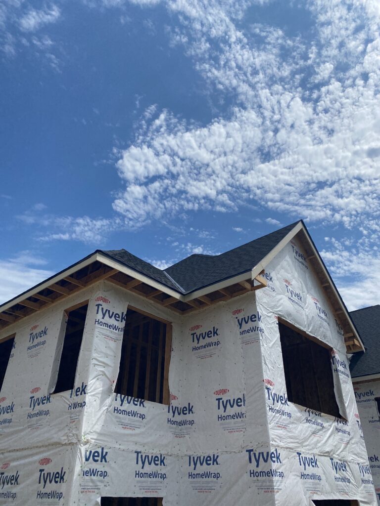 New shingle roof edge and gable detail over housewrap on a new construction home