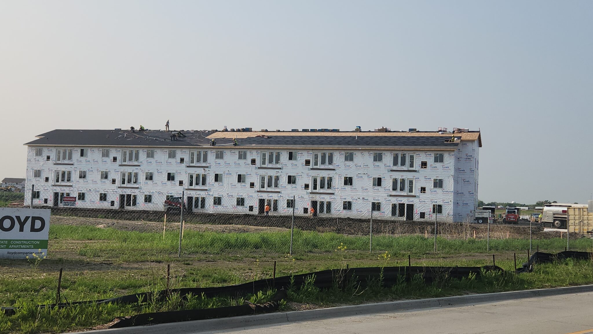 New three-story multifamily apartment building with a finished shingle roof