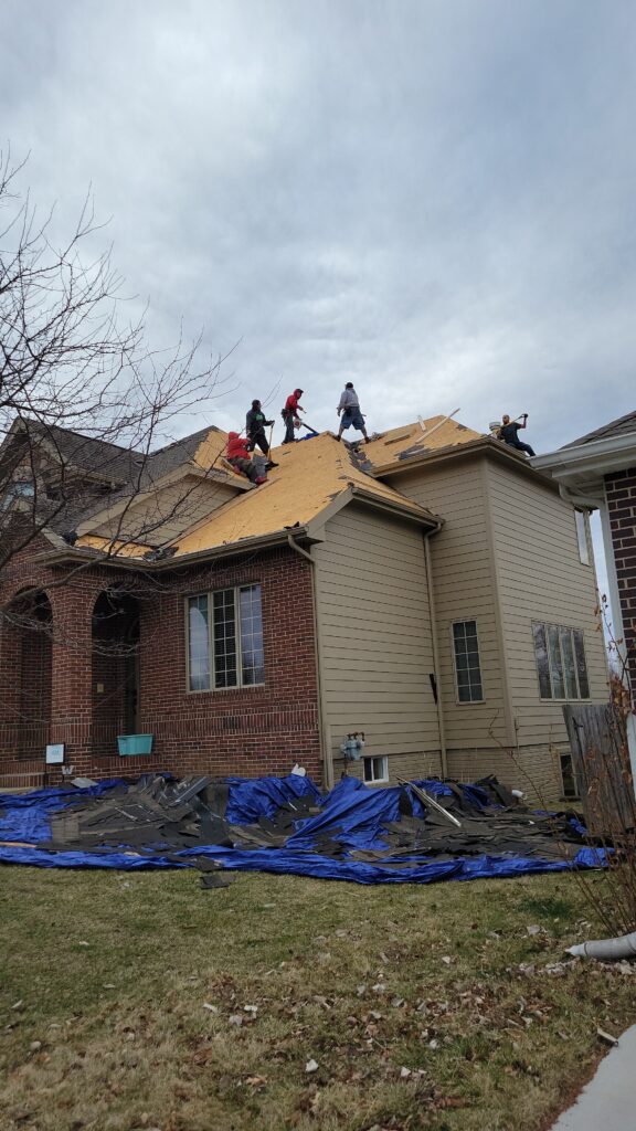 Roof Tear-Off, Hail Damage Replacement, Waukee Wolf Roofing crew tearing off a hail-damaged roof in Waukee