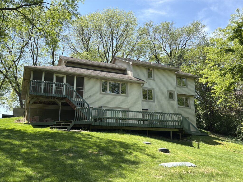 Back of Home Before Roof Replacement Back of a West Des Moines home with its old roof before replacement
