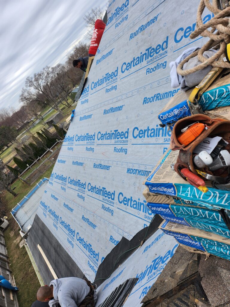 Wolf Roofing Crew Installing CertainTeed Underlayment Wolf Roofing crew installing CertainTeed underlayment