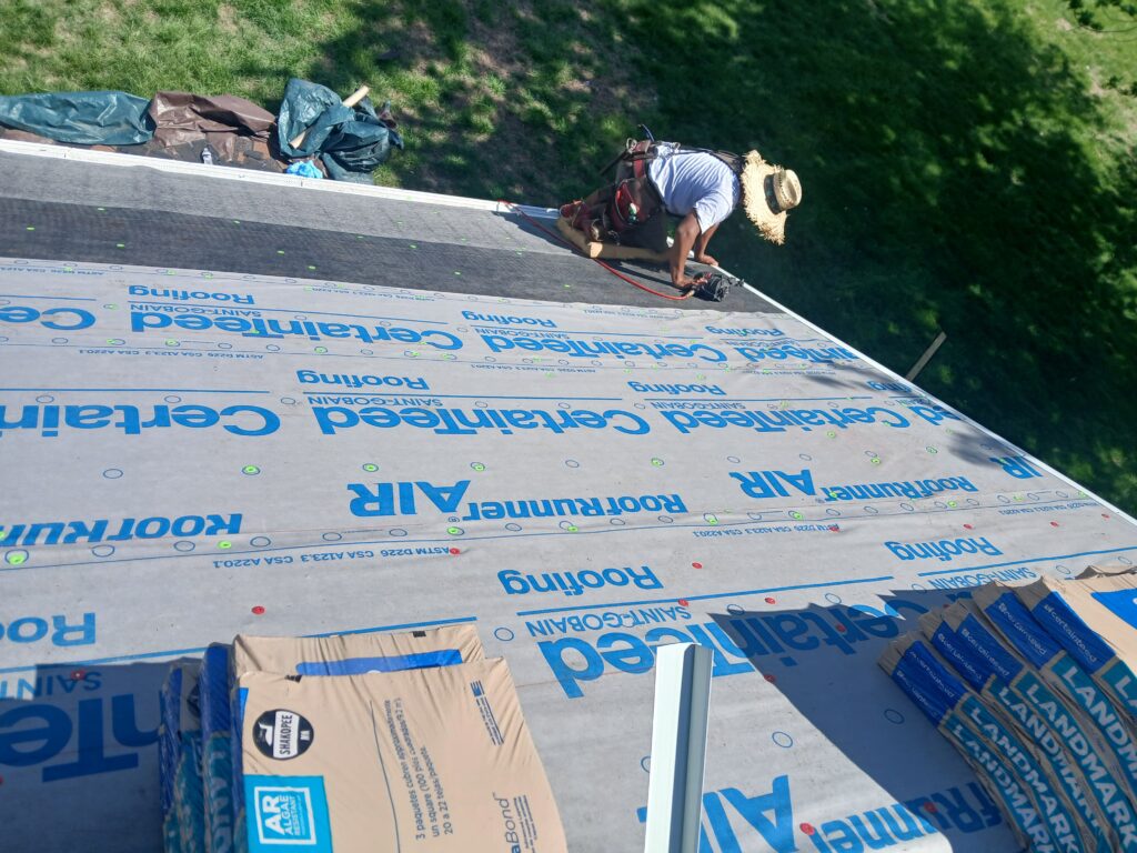 Crew Installing Underlayment West Des Moines Wolf Roofing crew installing underlayment in West Des Moines