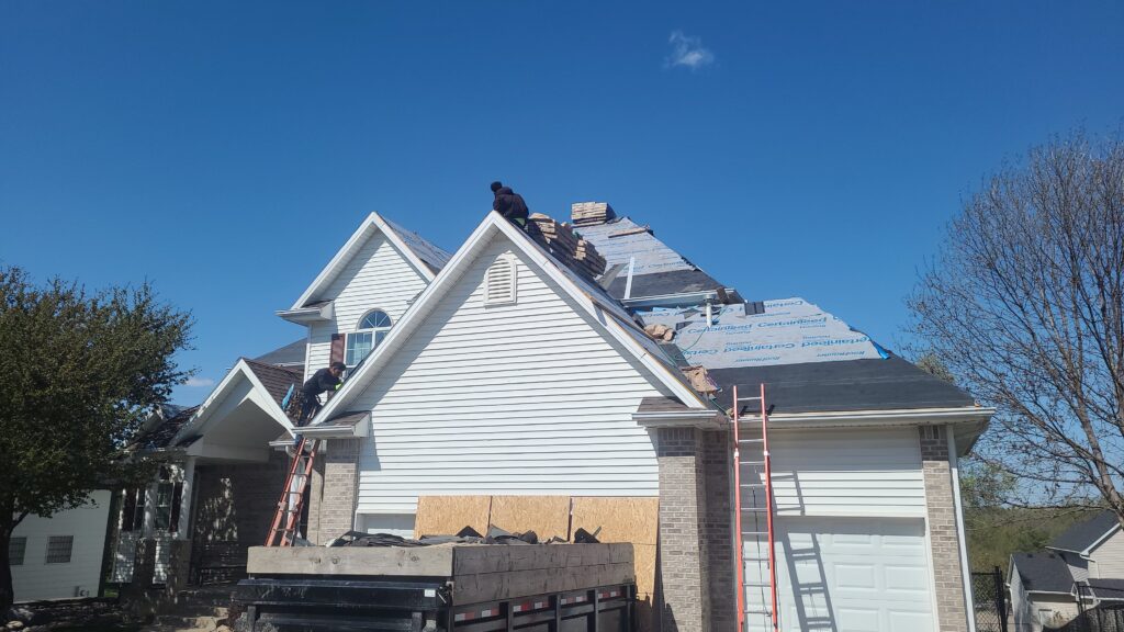 Wolf Roofing Crew Tear-Off Johnston Wolf Roofing crew tearing off old shingles on a Johnston, IA home