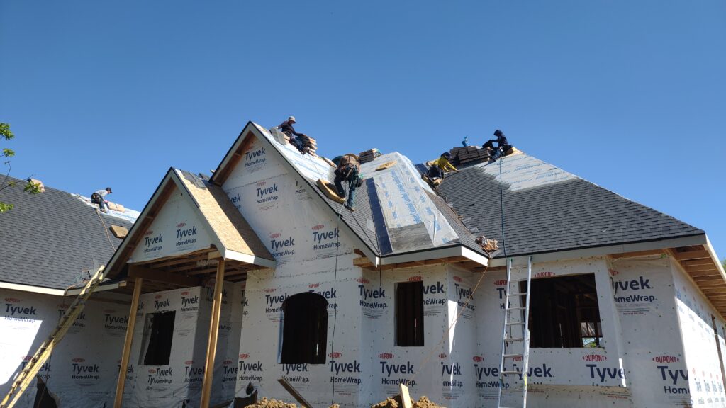 Wolf Roofing crew doing new construction roofing on a new home